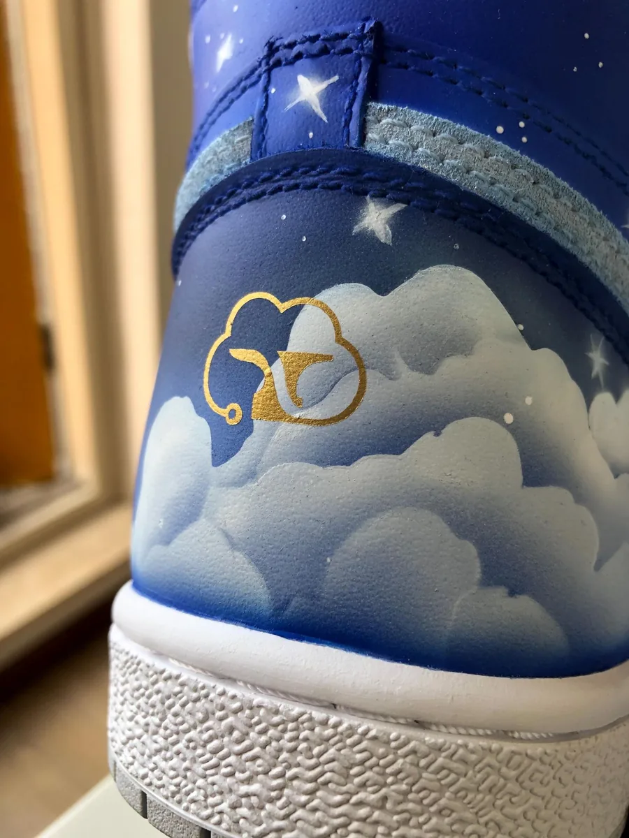 The heel: the CloudForged cloud-and-anvil mark painted in gold among the clouds